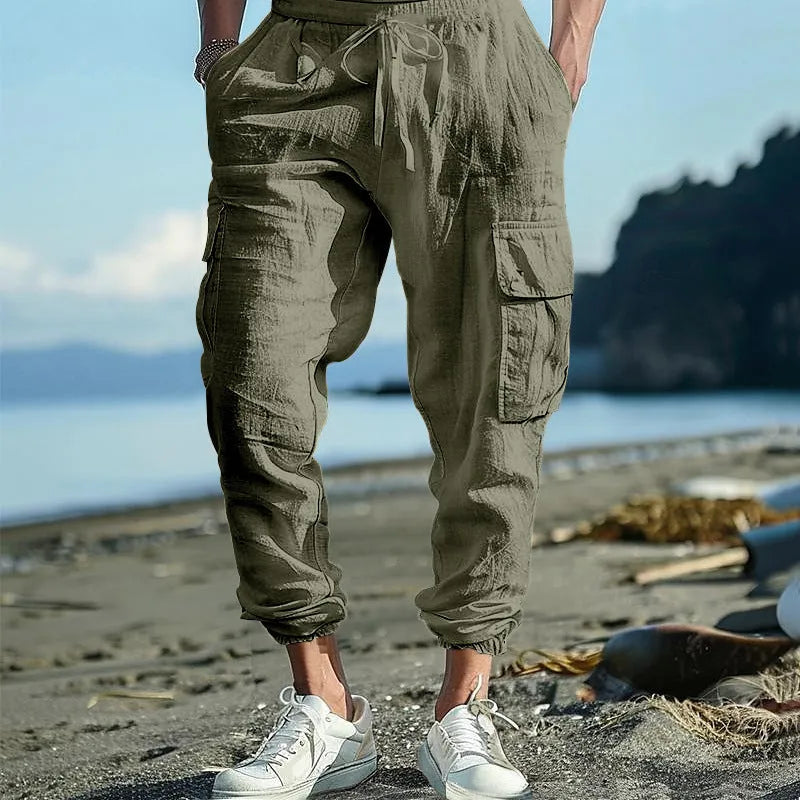 Men's loose-fit linen trousers in Army Green with ankle-tied cuffs and multiple pockets.