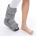 Achilles tendon rehabilitation walking boot in grey colour with adjustable strapping and rocker sole