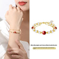 Sterling silver double-layer bracelet with cinnabar red bean and freshwater pearl beads, electroplated finish, geometric bean shape on white background