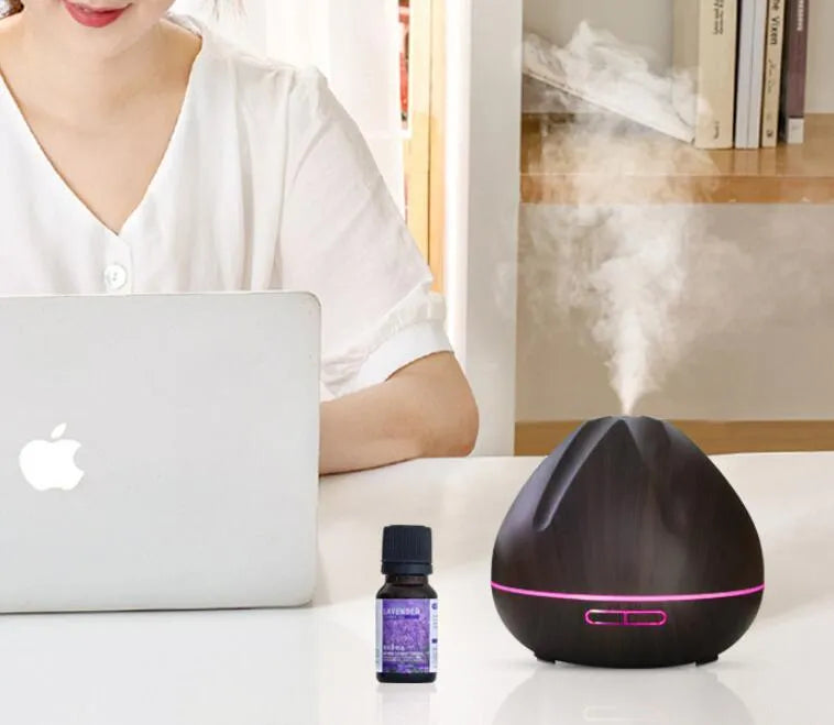 Air humidifier aromatherapy machine with 500ml capacity in dark wood finish on a table