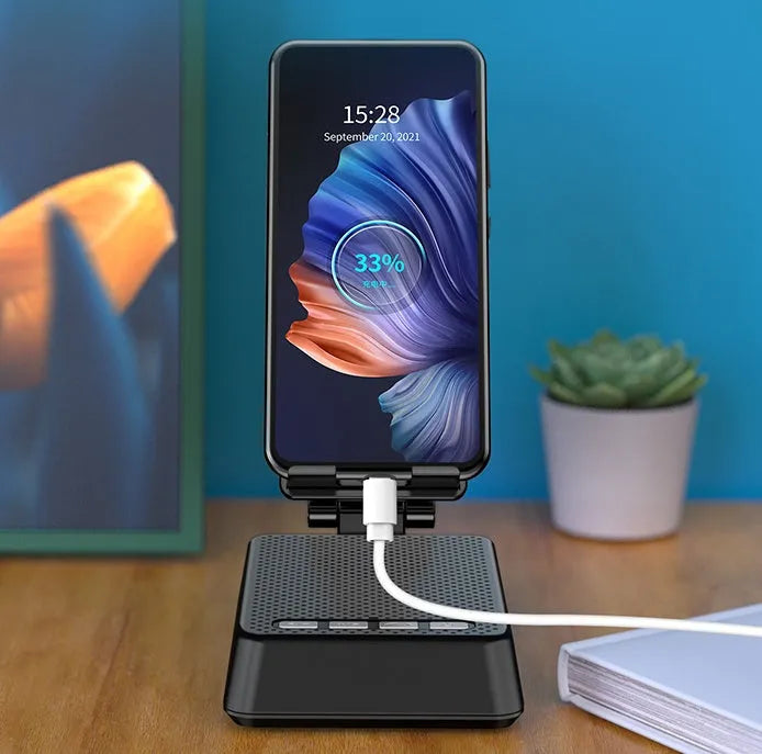Black mobile phone broadcasting stand with integrated Bluetooth speaker and microphone on desk