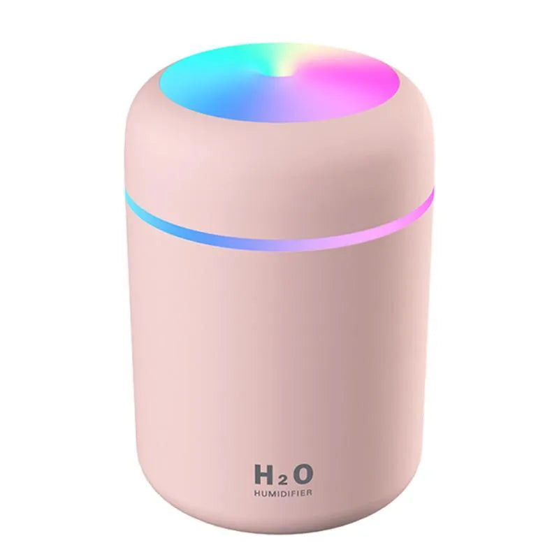 Pink USB desktop humidifier with colourful LED lights and 300ml water tank on wooden desk
