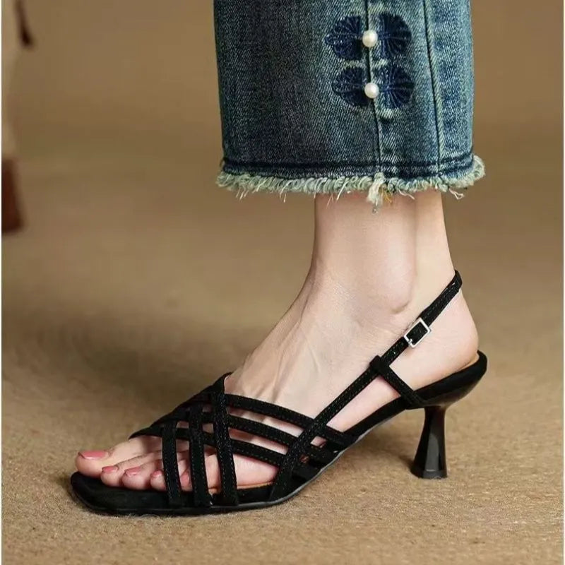 Women's light brown retro sandals with thin cross ankle straps and a square toe on a mid-height heel.