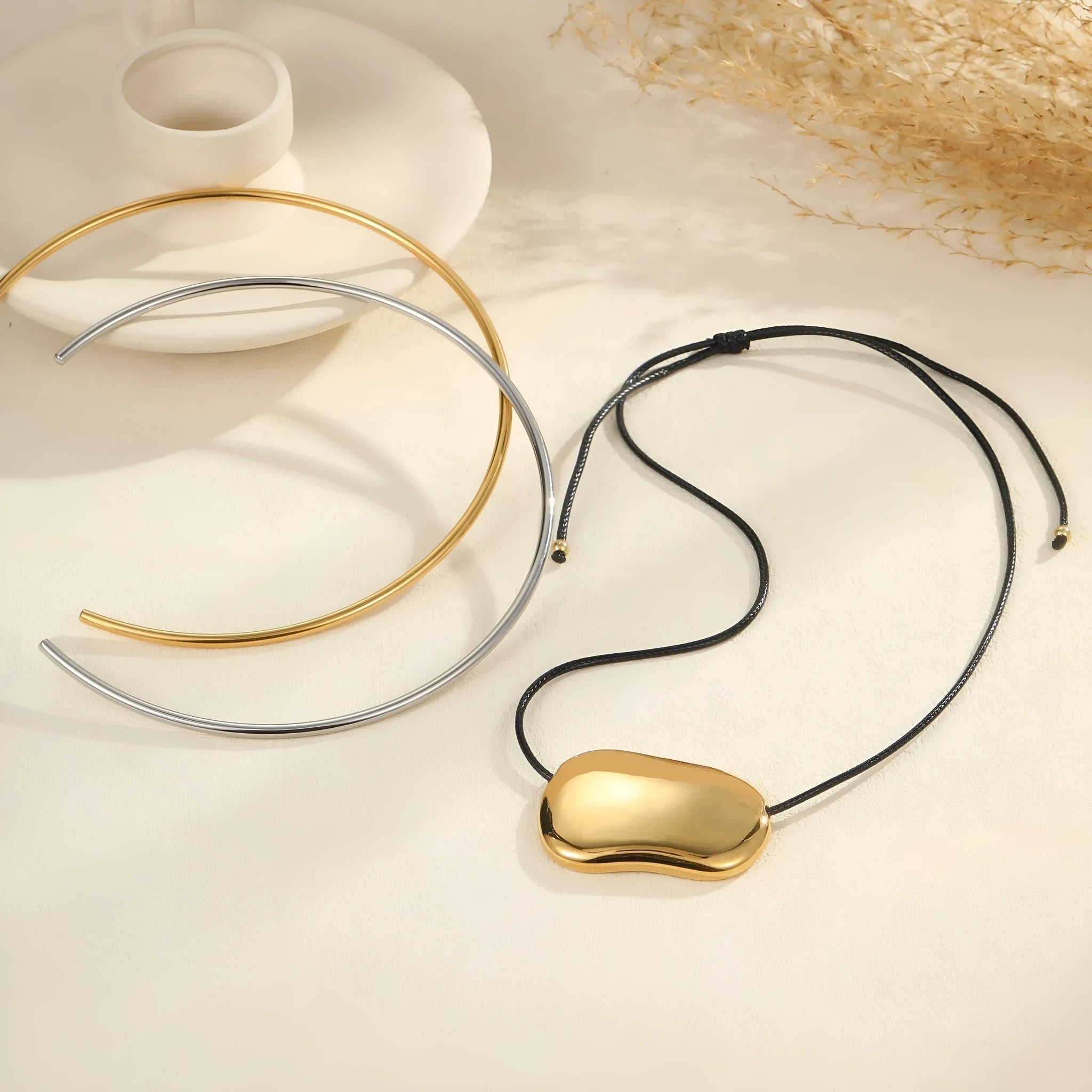 Gold and silver geometric titanium steel necklace showing collar and pendant style options.