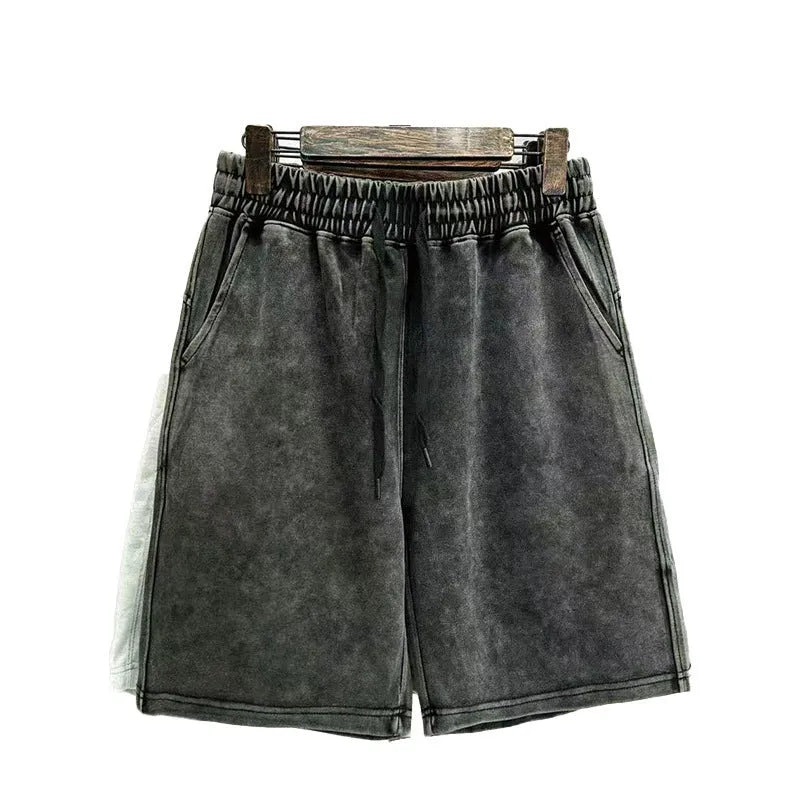 Men's solid colour distressed cotton shorts in a loose straight-leg casual fit.
