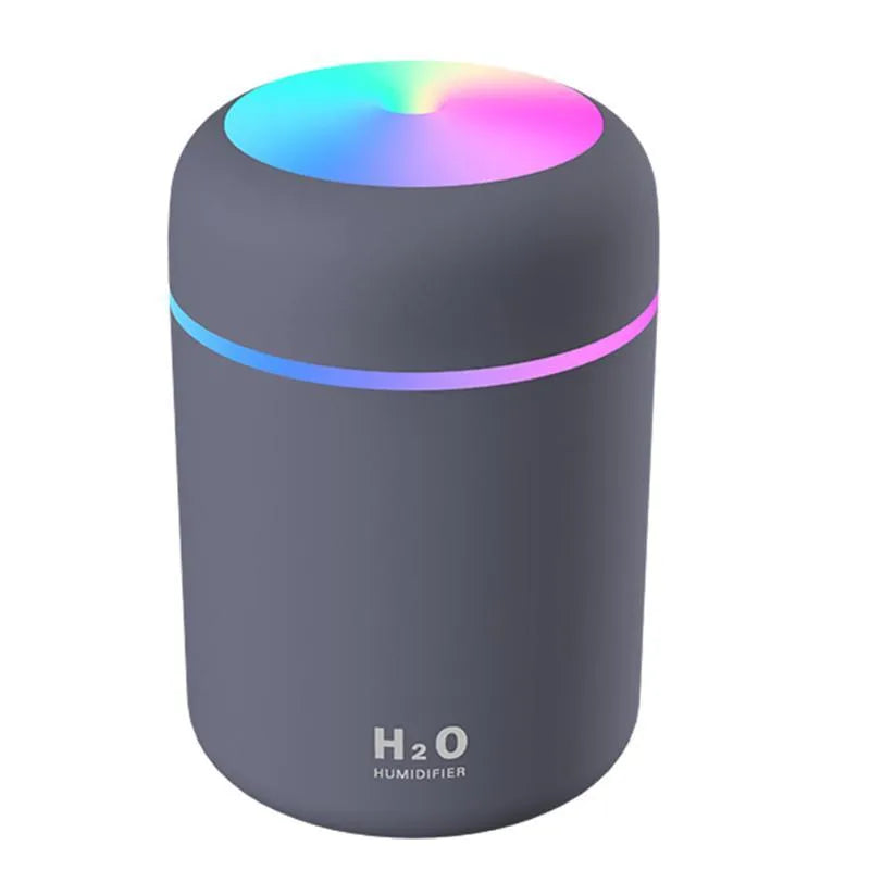 Pink USB desktop humidifier with colourful LED lights and 300ml water tank on wooden desk