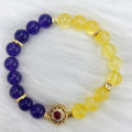 Handmade women's yellow and purple amethyst crystal bracelet on wrist