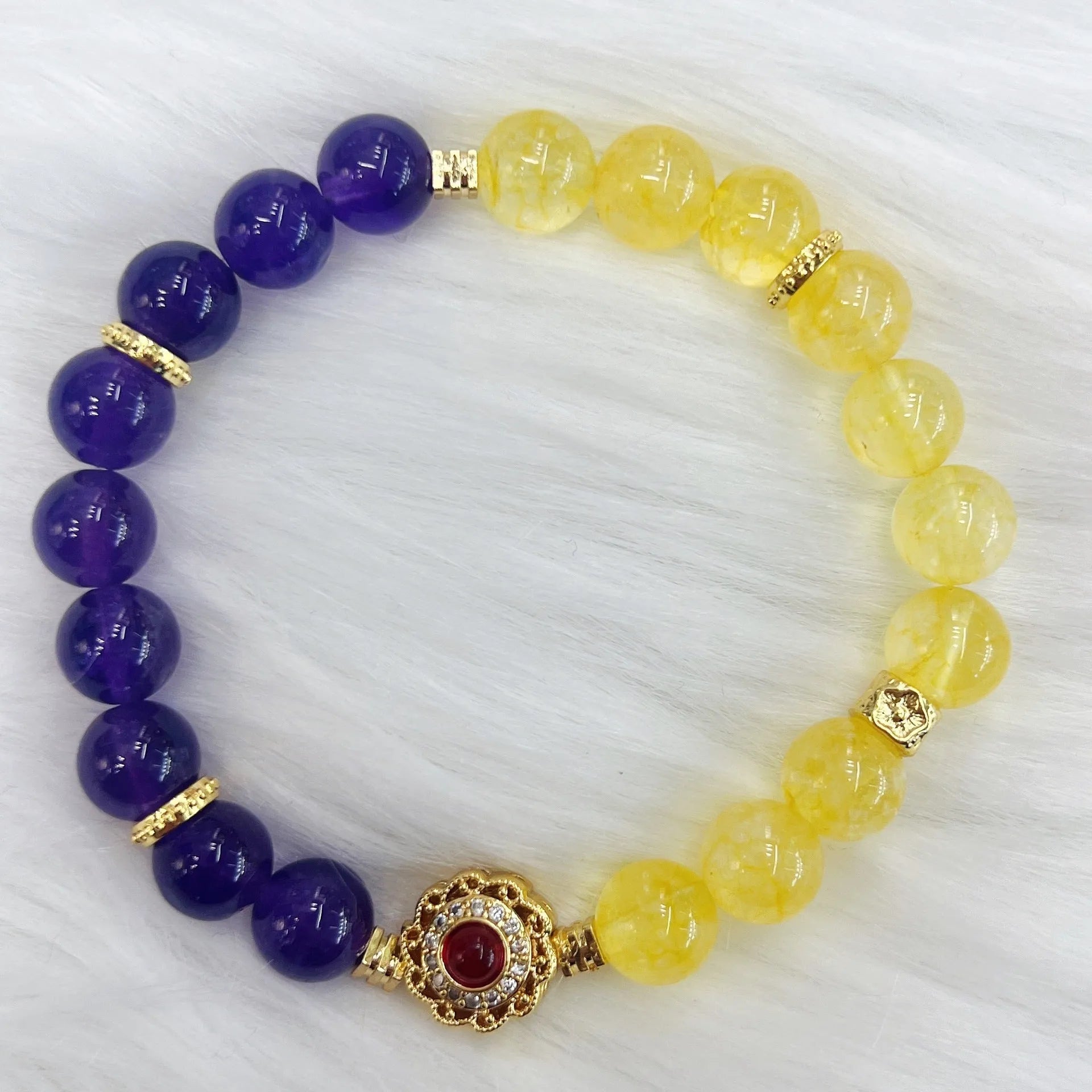 Handmade women's yellow and purple amethyst crystal bracelet on wrist