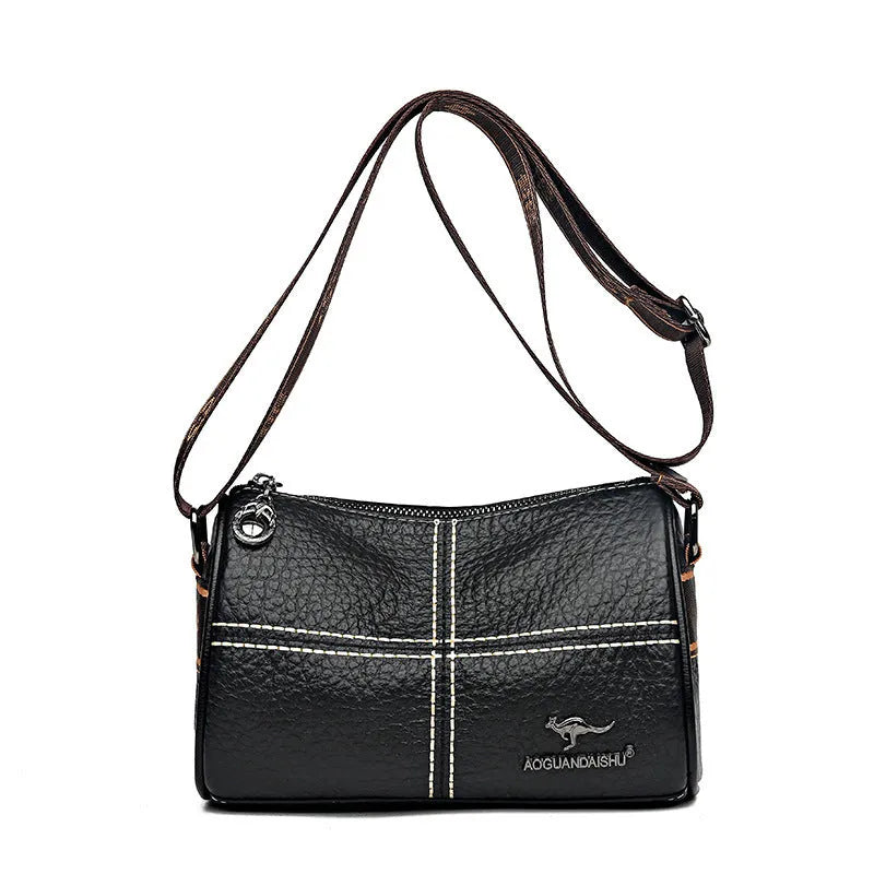 Women's casual stitched genuine leather shoulder bag in cylindrical shape, available in black, brown, green, and white