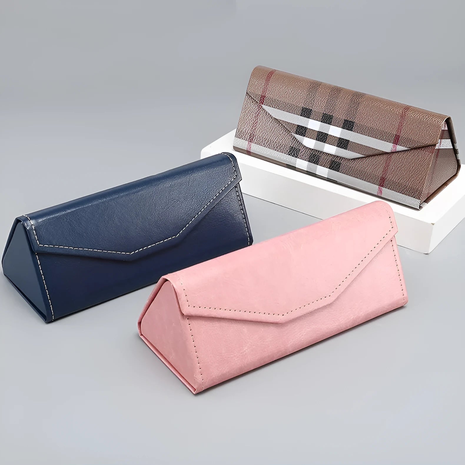 Black triangle folding glasses case with handmade stitching on PU cowhide exterior