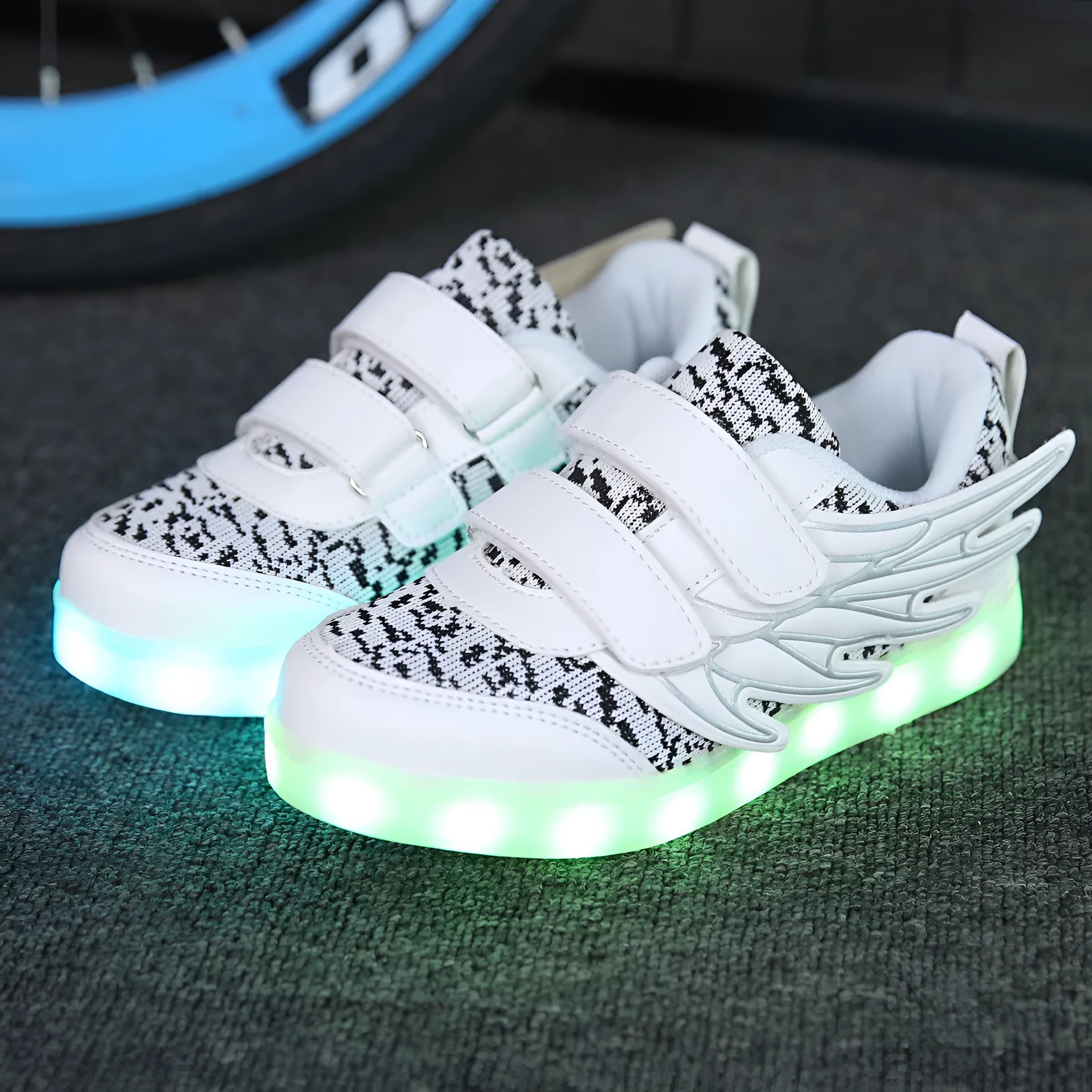 Children's plum red and white LED light up sneakers with USB charging port visible