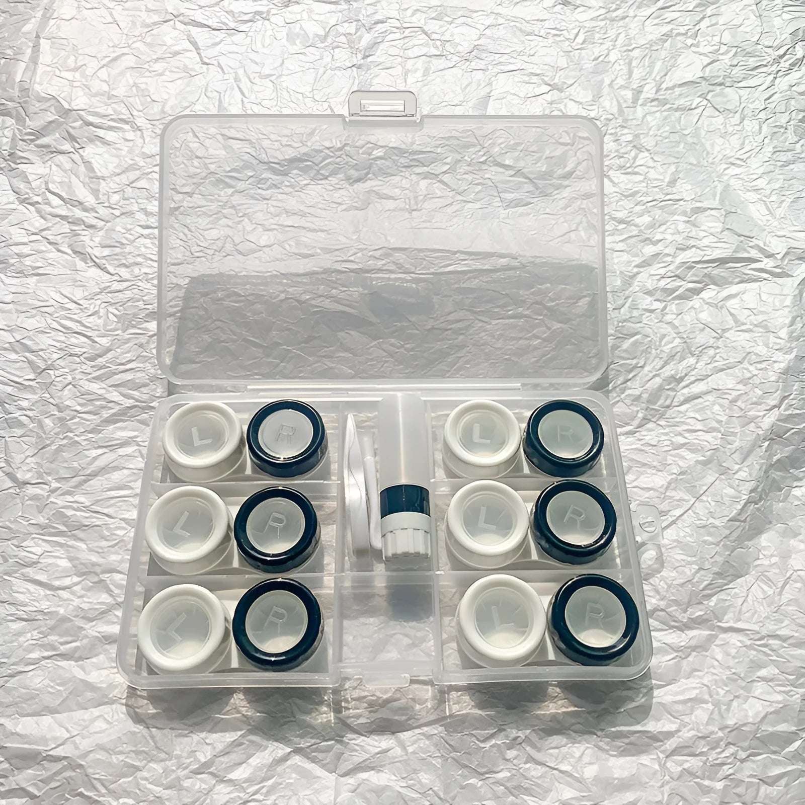 Portable rectangular contact lens case in various colours with a compact design.