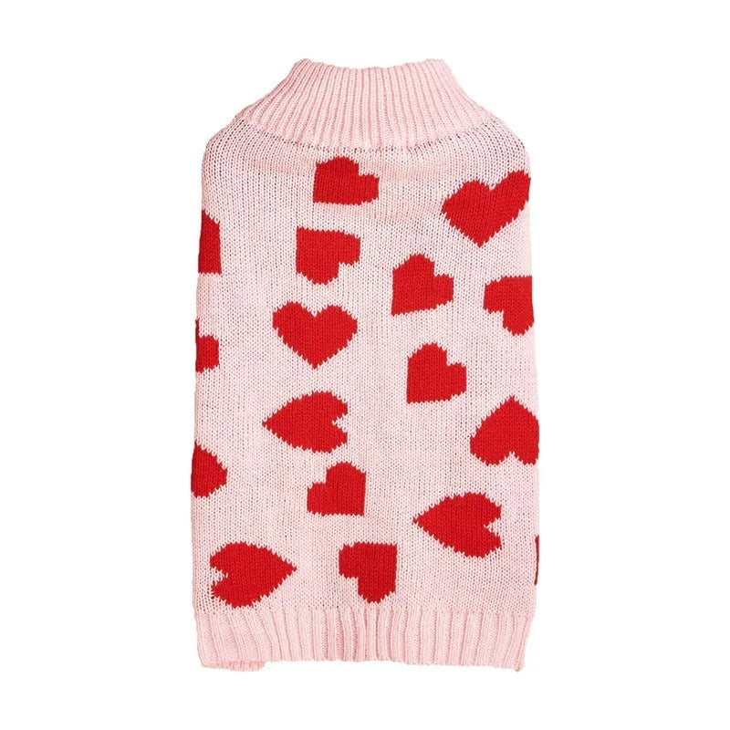 Red dog sweater with a white love heart and bow design on a small dog.