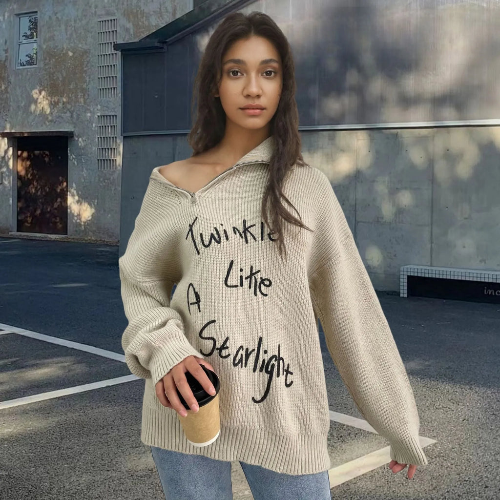Light khaki women's alpaca wool sweater with a diagonal front zip and loose lapel turtleneck collar.