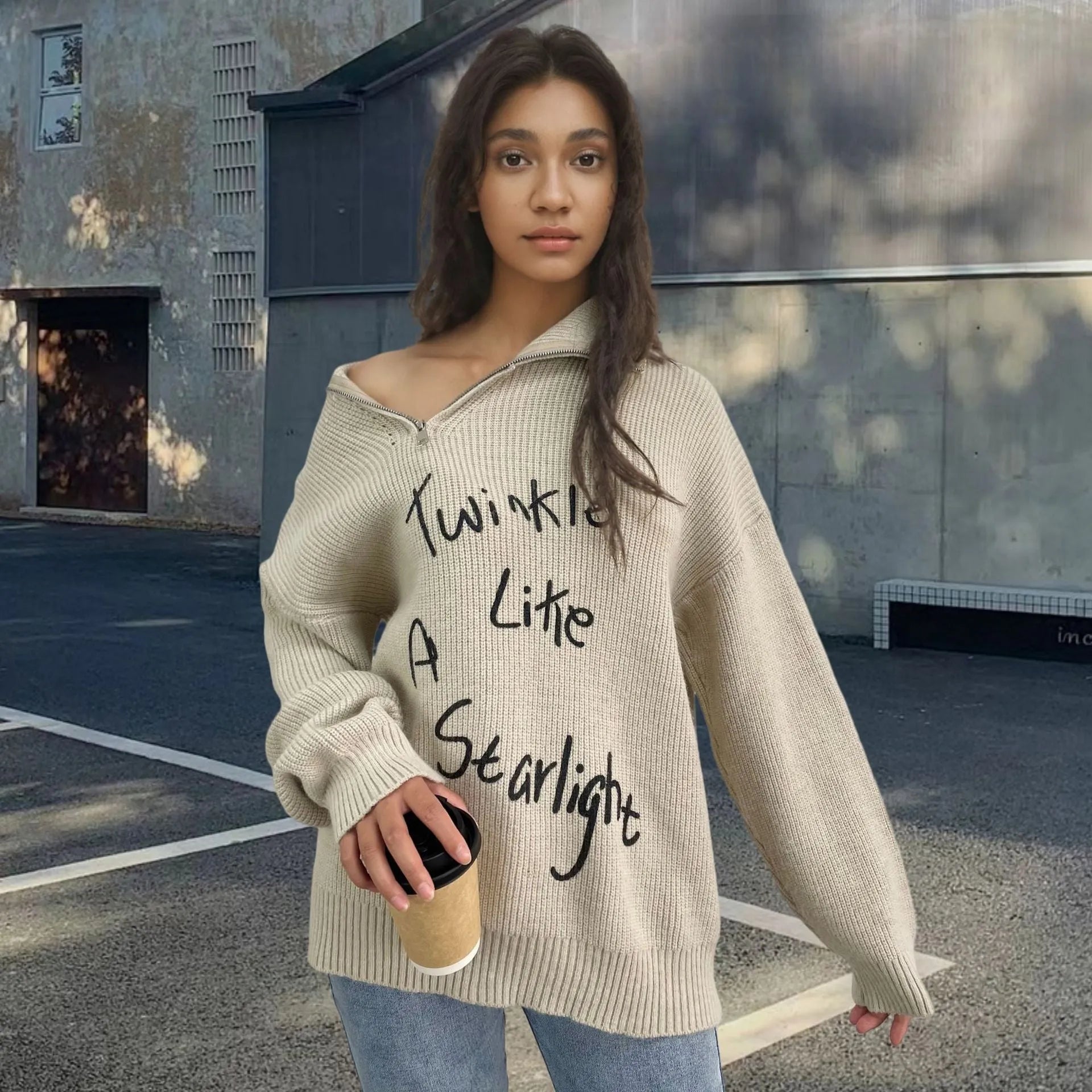 Light khaki women's alpaca wool sweater with a diagonal front zip and loose lapel turtleneck collar.