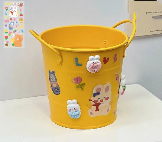 Round metal desktop pen holder showing colour options including green, pink, red, white and yellow