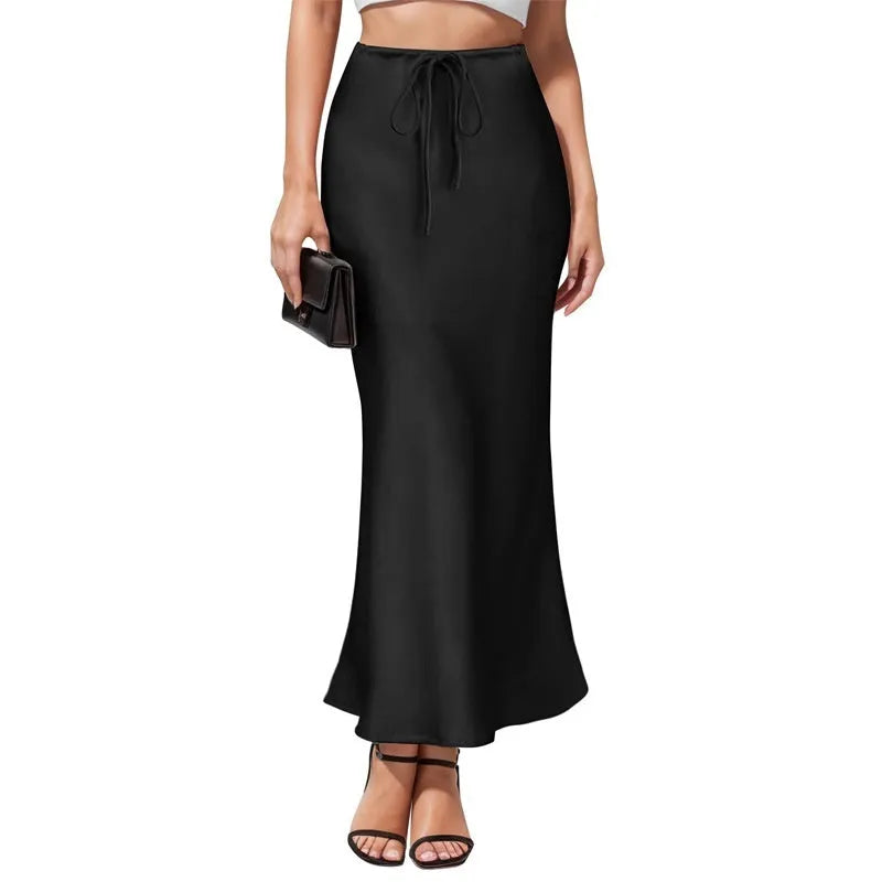 Women's asymmetric acetate satin skirt in a solid colour with high waist and irregular stitching detail.