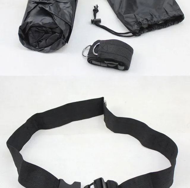 Black 56 inch running speed training parachute with adjustable waist belt on outdoor track