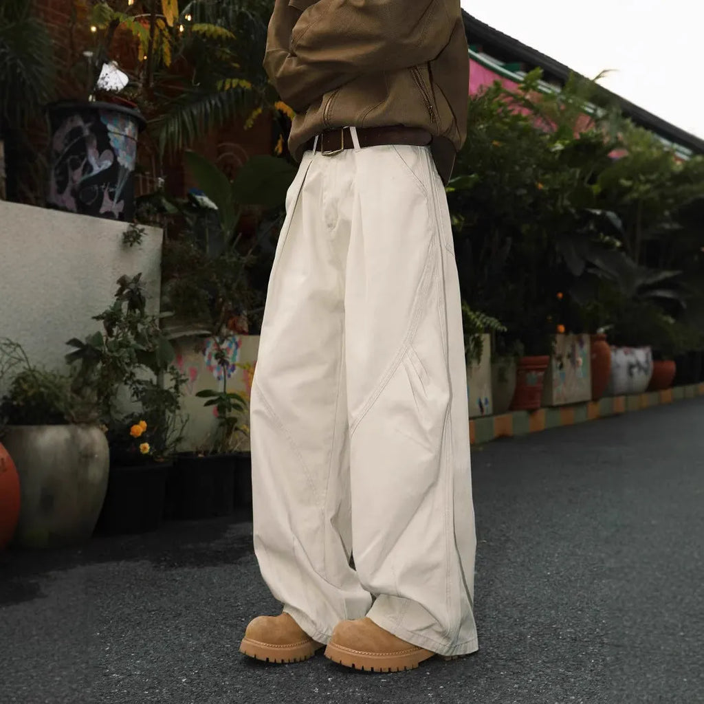 Men's pleated straight-leg trousers in apricot colour on a hanger