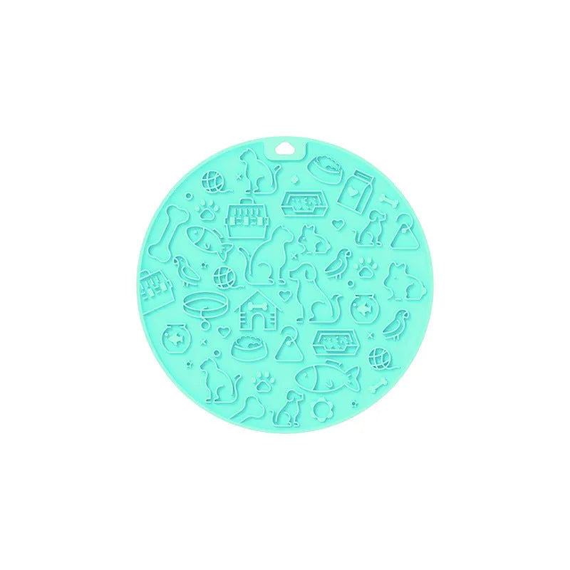 A blue silicone pet licking mat with a suction cup base on a kitchen floor.