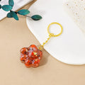 Small natural crystal cat's paw keychain pendant on a metal ring.