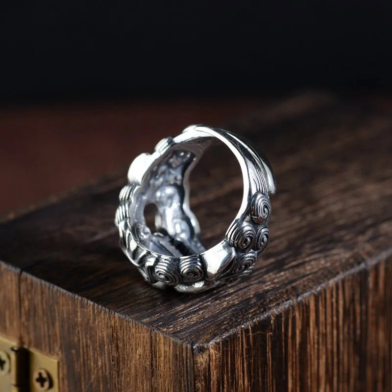 Silver open style diamond ring with a detailed jibeast and animal zodiac pattern.