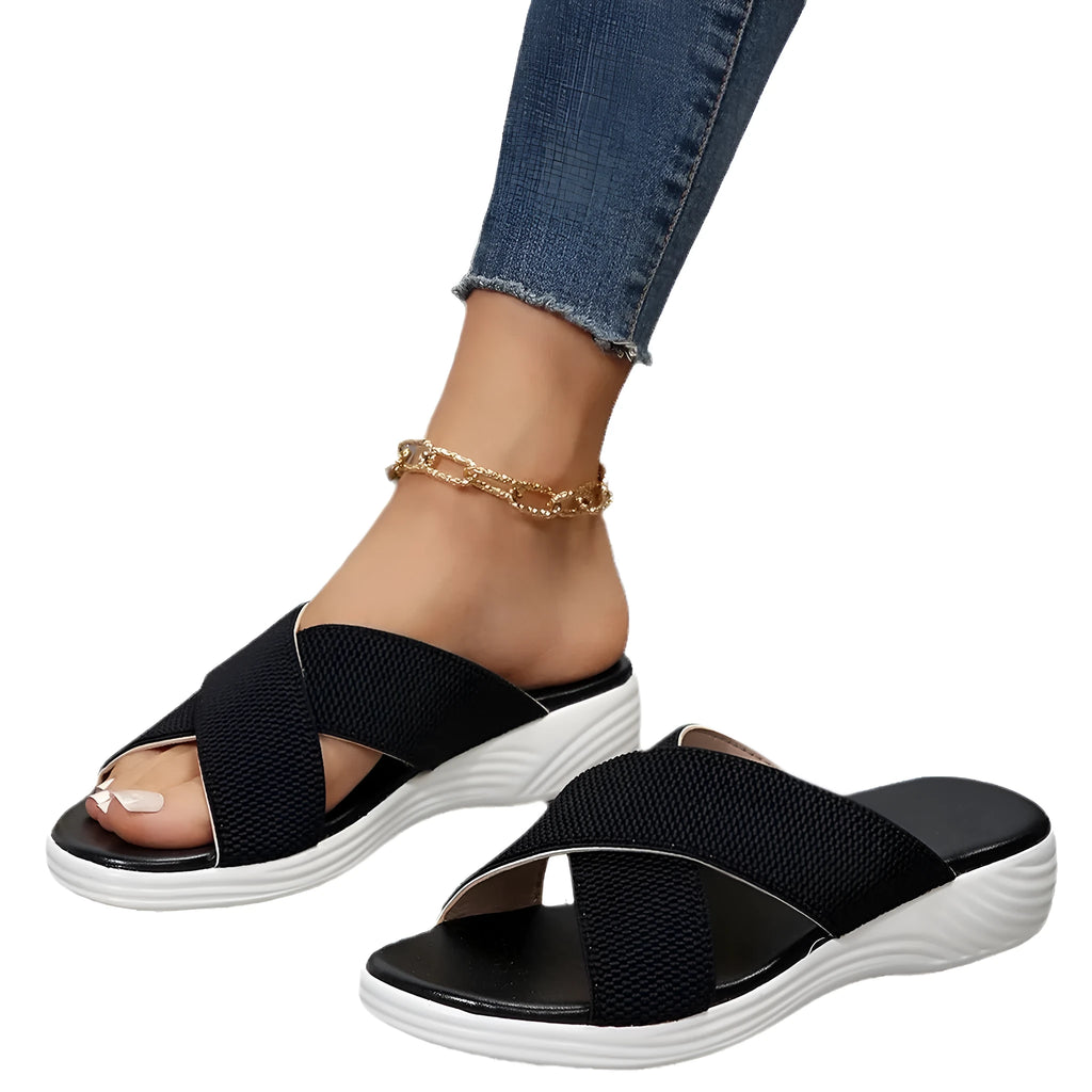 Women's black flat wedge slippers with peep-toe design and cross-strap detailing