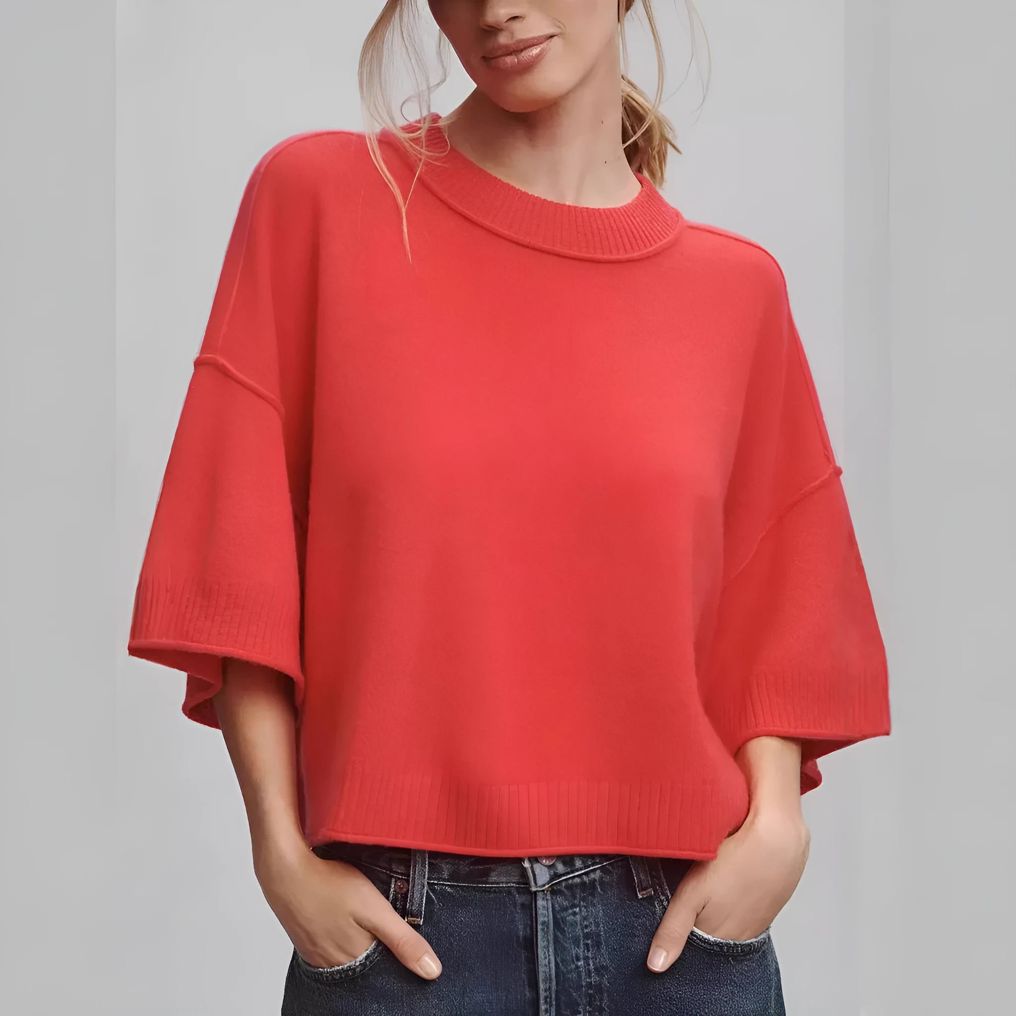 Red short sleeve viscose crop top with an exposed navel design on a model.