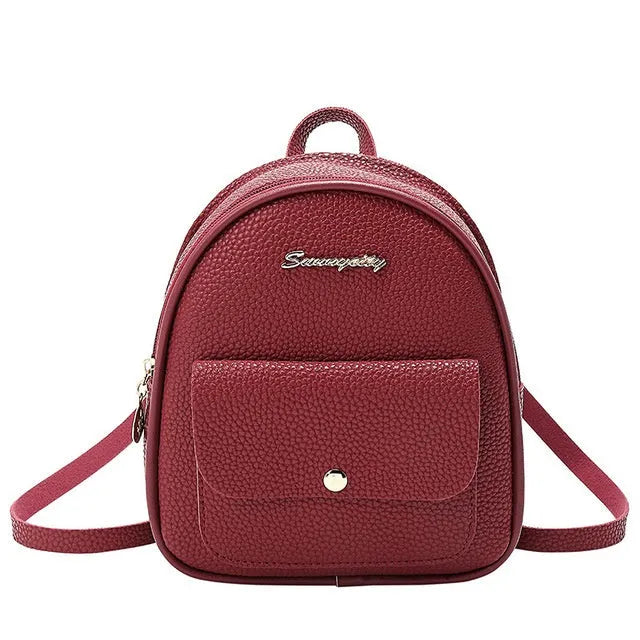 Women's compact black PU bag worn as both a shoulder bag and a small backpack.