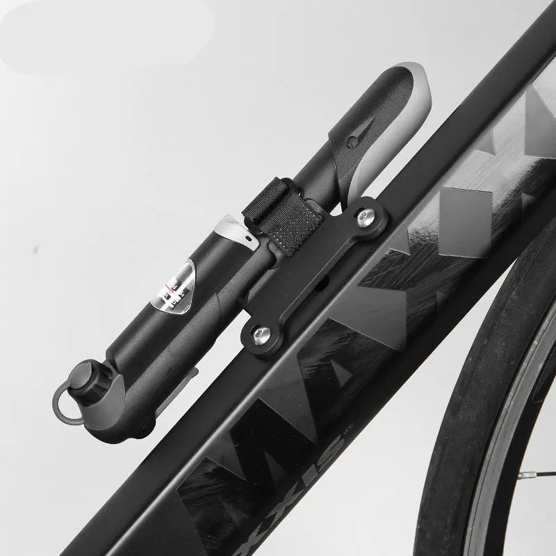 Black bicycle mini pump with round handle, 18cm length, 106g weight, on a wooden surface with bracket and mounting tape