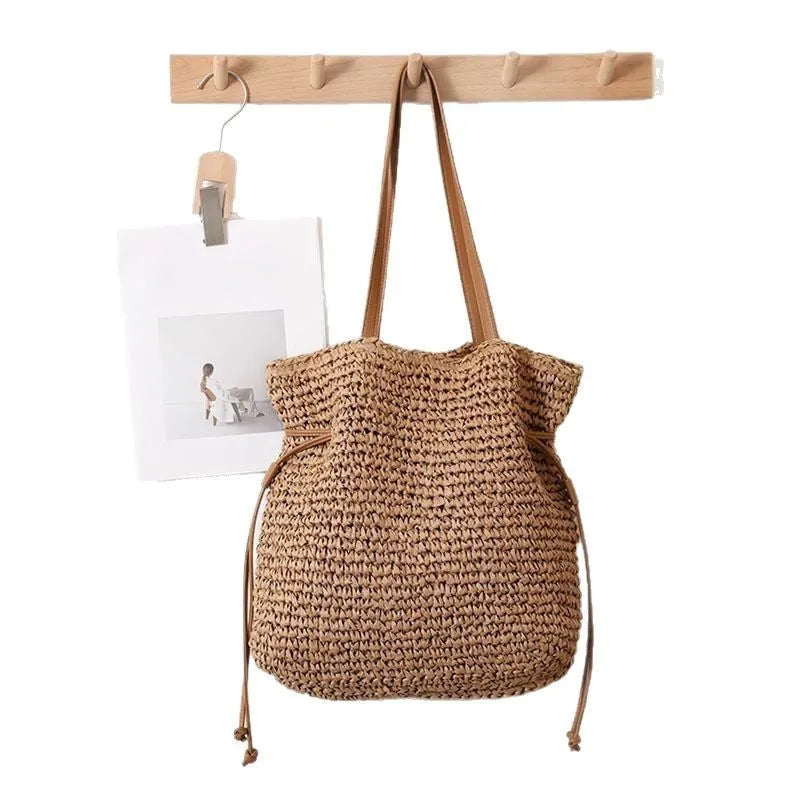 Large capacity paper straw drawstring shoulder bag in beige with double straps and inner pocket