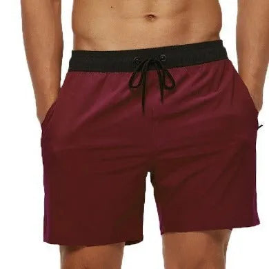 Men's blue running shorts with a stitching waistband, drawstring, and a side zippered pocket.