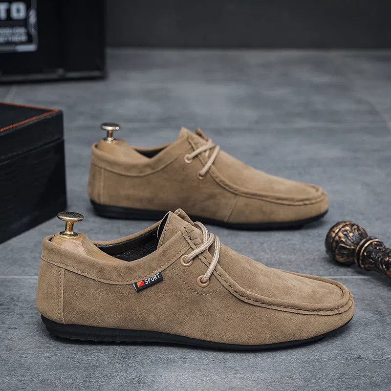 Men's black slip-on loafers with synthetic PU upper, stitched detailing, and non-slip plastic sole