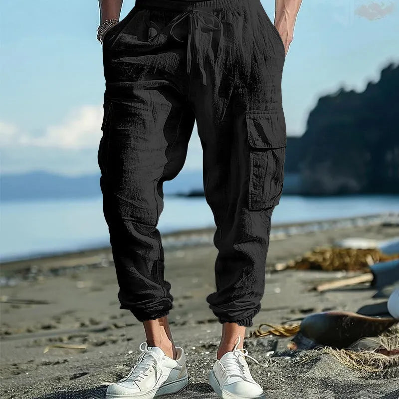 Men's loose-fit linen trousers in Army Green with ankle-tied cuffs and multiple pockets.