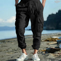 Men's loose-fit linen trousers in Army Green with ankle-tied cuffs and multiple pockets.