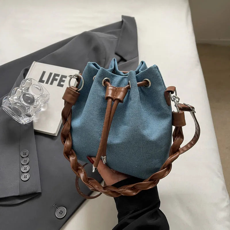 Blue cross body bucket messenger bag with synthetic leather lining and sandwich pocket organisation