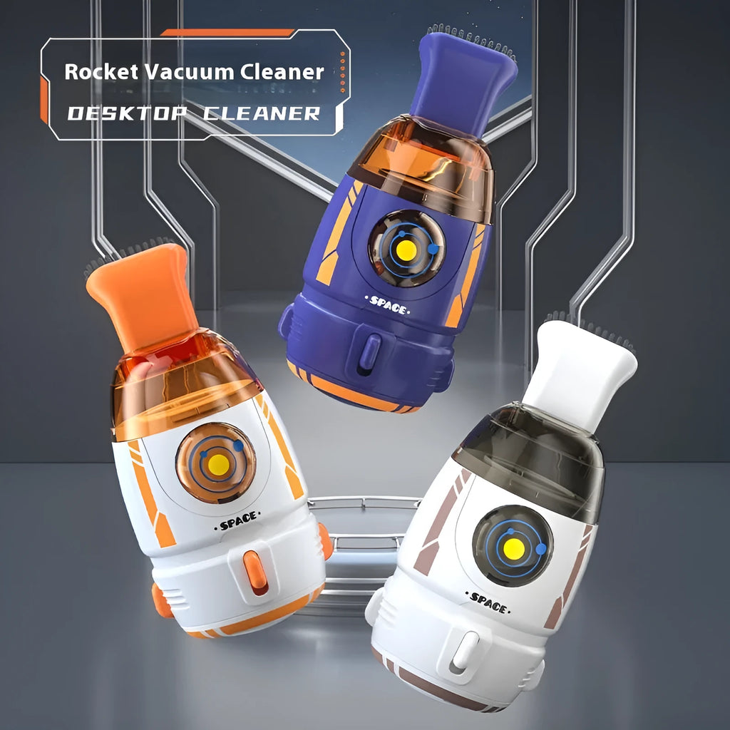 Handheld desktop vacuum cleaner in blue rocket design with USB charging cable on a wooden desk.
