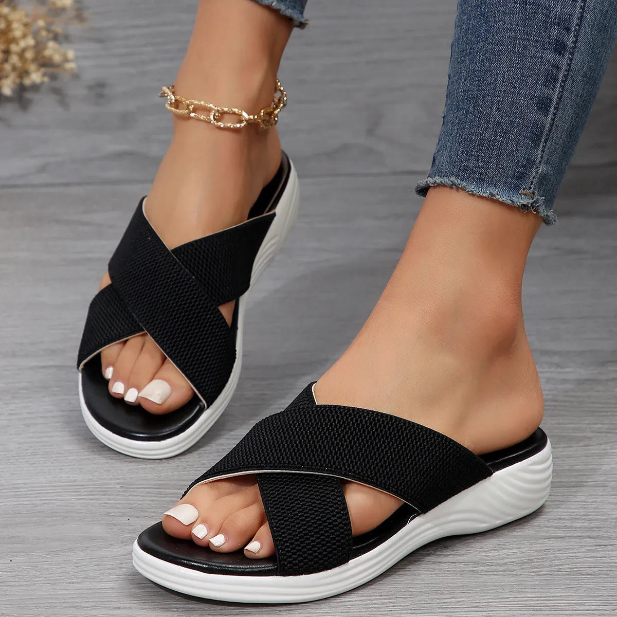 Women's black flat wedge slippers with peep-toe design and cross-strap detailing