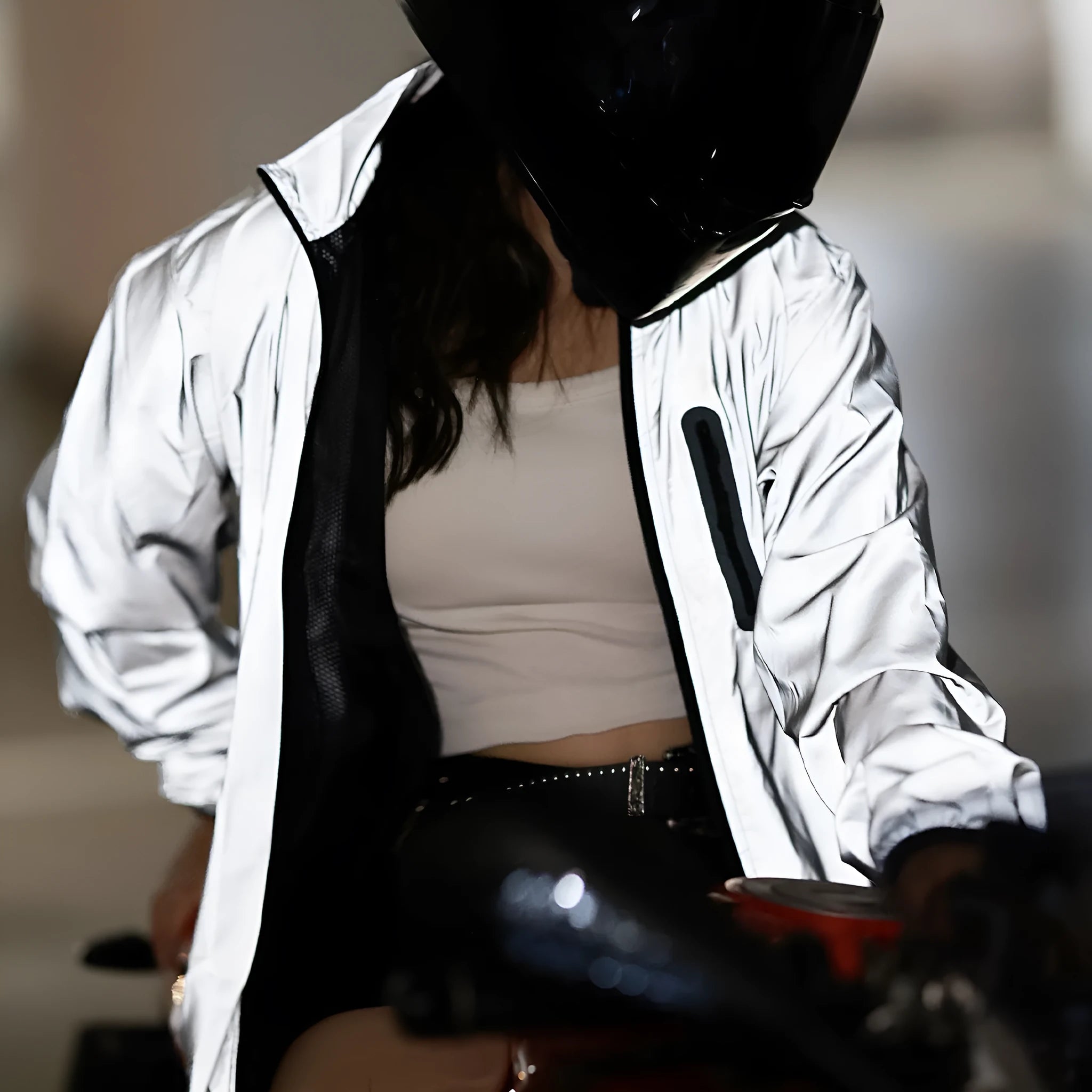 Silver waterproof polyester long sleeved jacket for outdoor wind and rain protection.