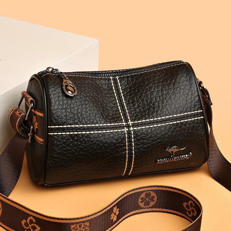 Women's casual stitched genuine leather shoulder bag in cylindrical shape, available in black, brown, green, and white