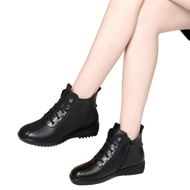 Women's casual shoes in black artificial PU with mid heel, side zipper, and round toe on light background