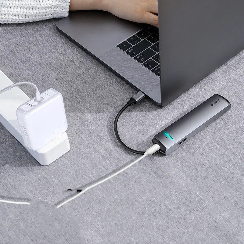 Mechanical Eye Type-C Docking Station in dark grey, compatible with MacBook and iPhone, on a desk