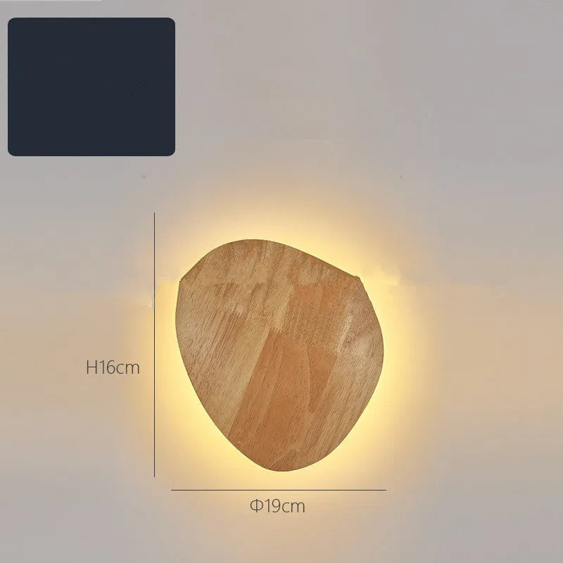 Log Art wood LED wall lamp with oval shape and warm light on a white wall