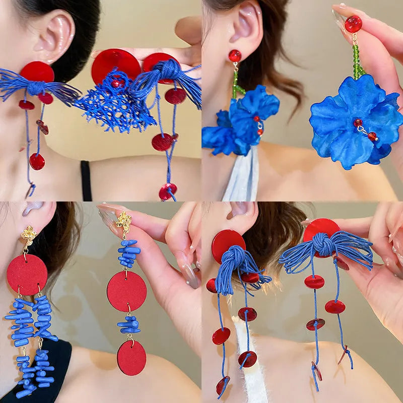 Geometric cloth earrings with blue resin flower detail and round design elements