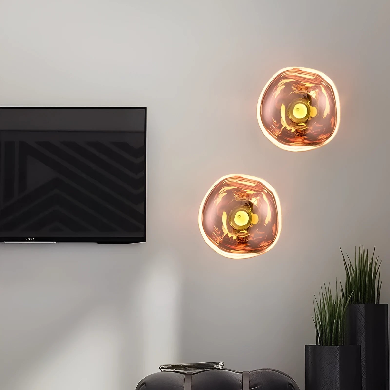 Modern lava wall lamp with acrylic shade in gold finish on a corridor wall emitting warm light