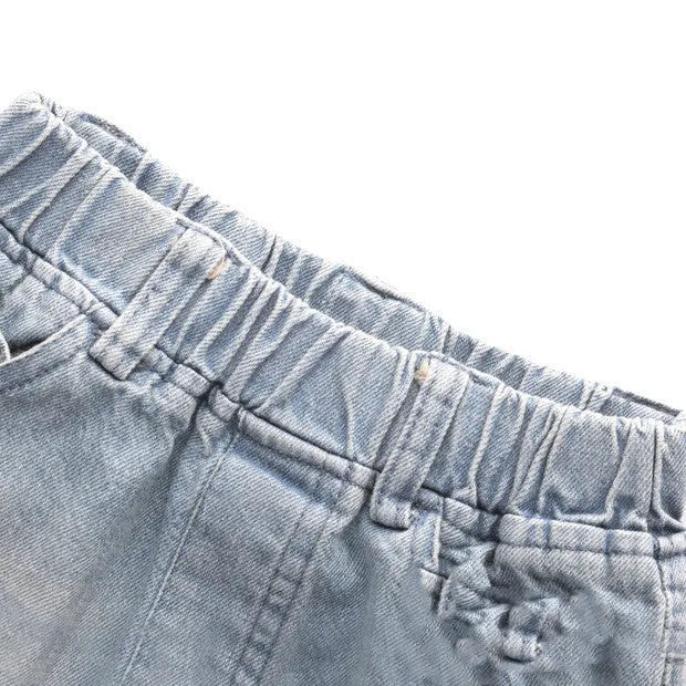 Light blue children's cotton skinny slim jeans laid flat showing slim leg and regular waist