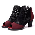 Women's black lace gladiator sandals with square high heel and zip closure, showing flower pattern detail