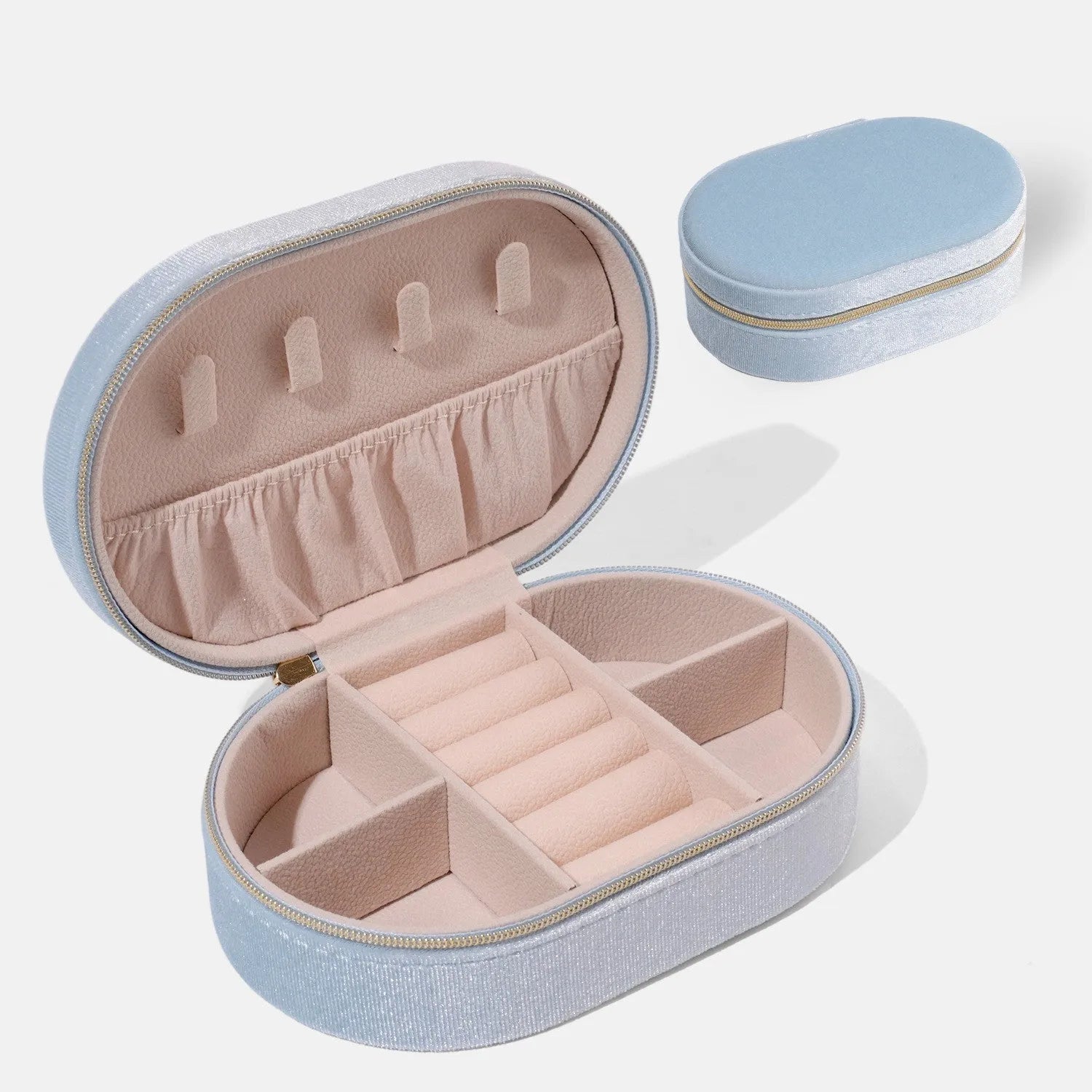 Oval velvet jewellery box with handle in lake blue colour, showing flannel-lined interior.