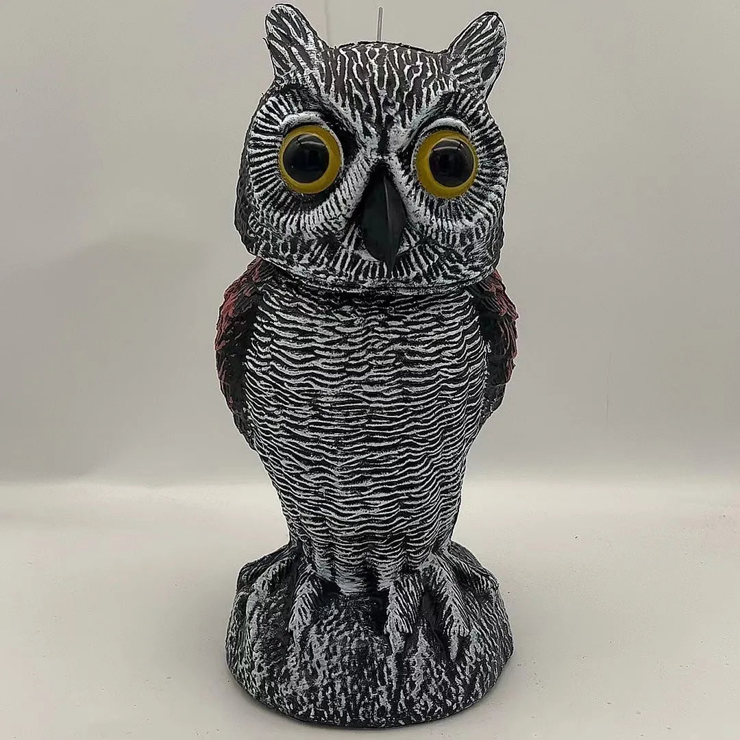 Artificial owl bird scarer decoy with shaking head motion in outdoor setting