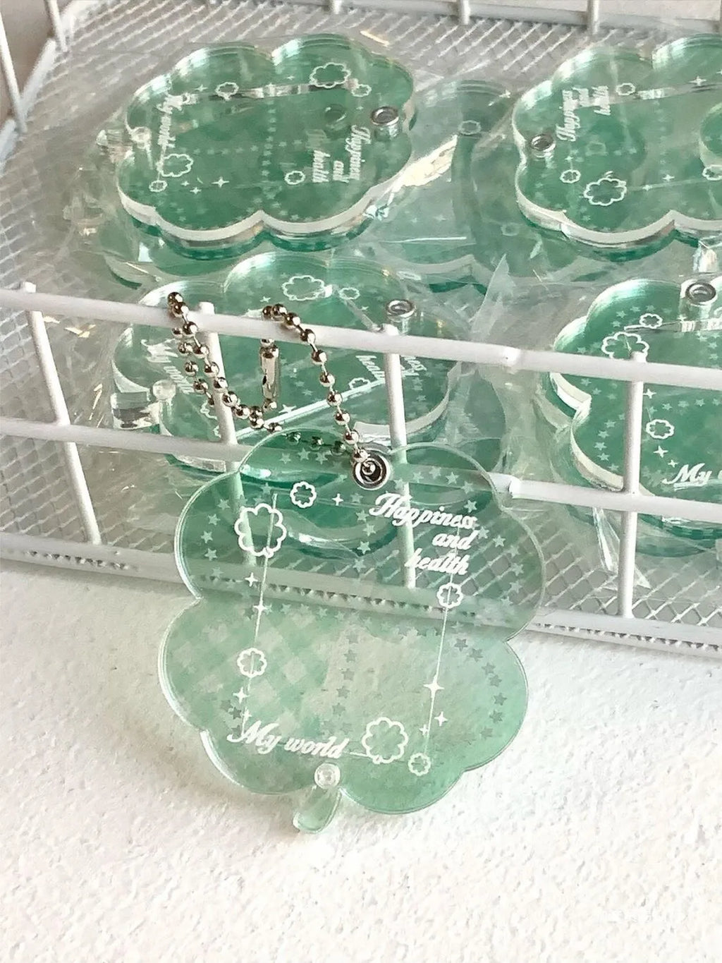 Acrylic four-leaf clover keychain pendant in blue, green, or mint colour options.